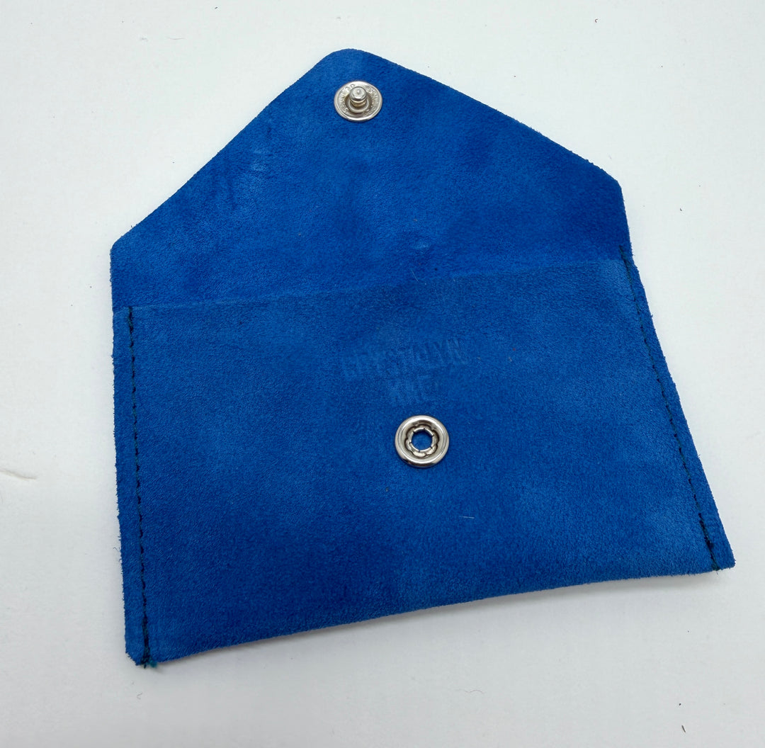 Blue fabric pouch with metal grommets on a white background #color_blue-suede