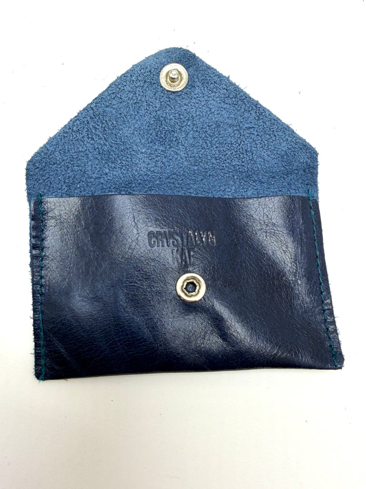 Blue leather pouch with button closure on a white background #color_navy