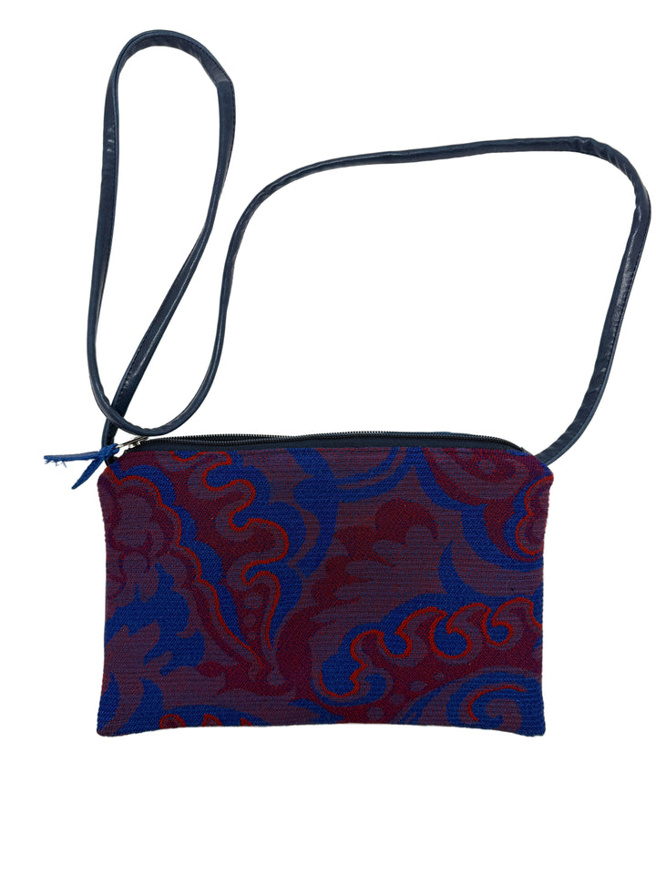 Small pouch with blue and red pattern on a white background#color_western-airlines-paisley-red
