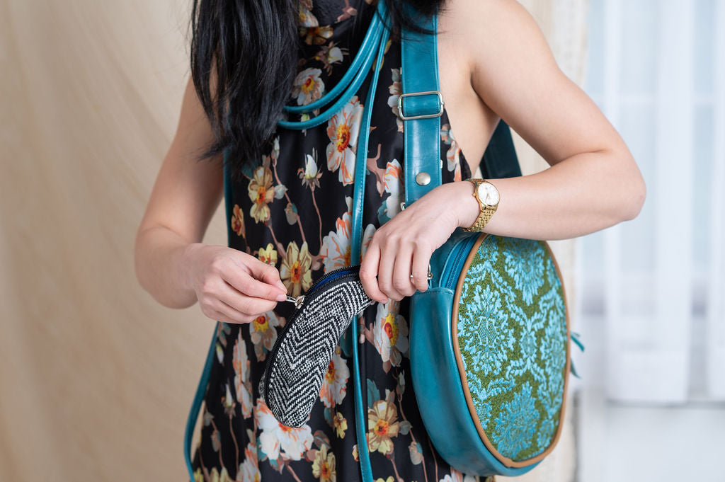 Person holding a black and white Glasses Cases made in USA#color_crosswind-chevron