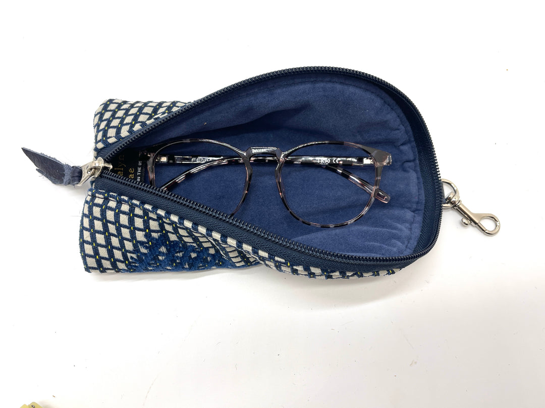 Blue and white checkered glasses case with round eyeglasses on a white background#color_constellation-cobalt