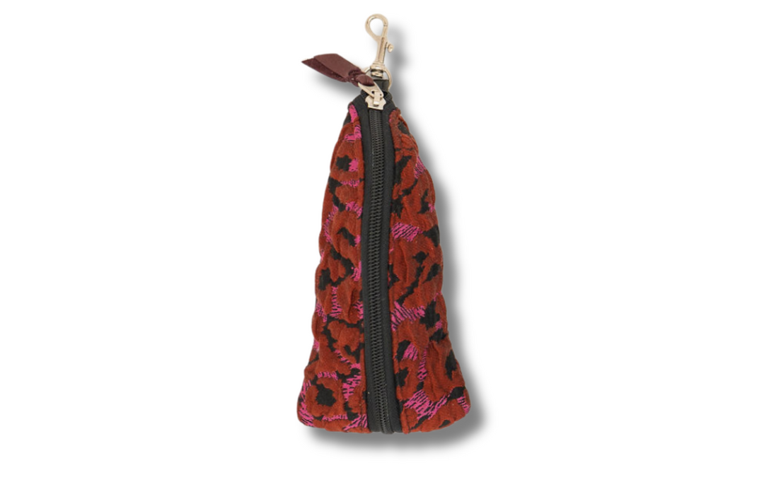 Red and black patterned keychain pouch with a zipper on a white #color_pink-panther-poppies