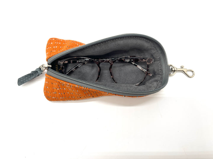 orange zippered case with orange interior holding a pair of glasses on a white background#color_tangerine-takeoff
