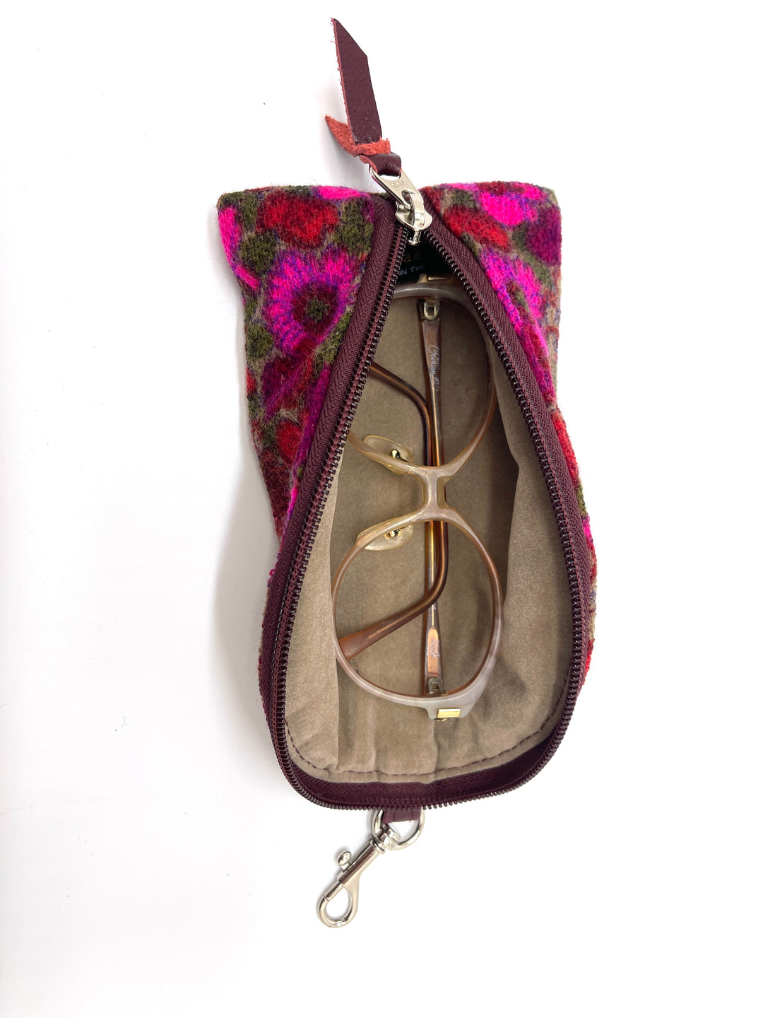 Floral-patterned zippered pouch with sunglasses inside on a white #color_twilight-dahlia