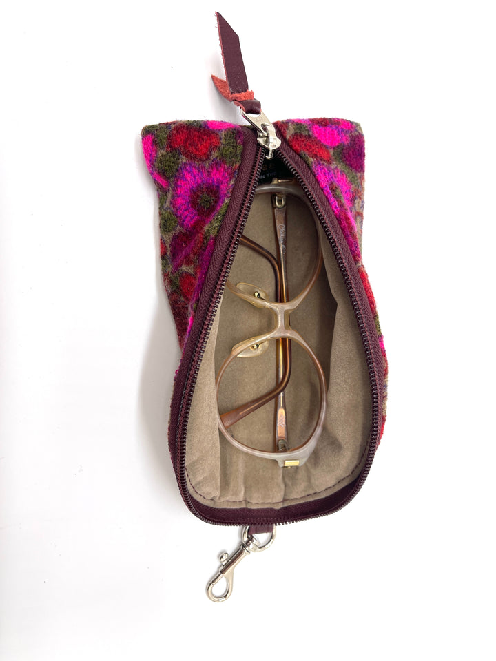 Floral-patterned zippered pouch with sunglasses inside on a white #color_twilight-dahlia