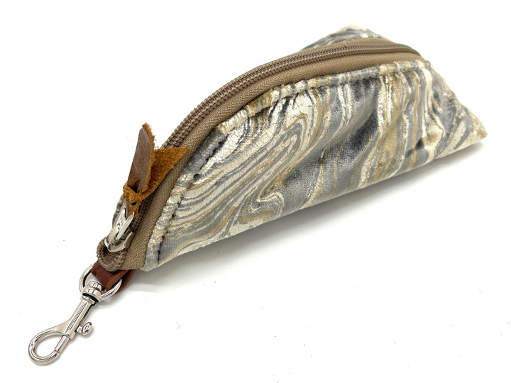 Marbled patterned pouch with a zipper and keychain clip on a white background#color_champagne-cosmos