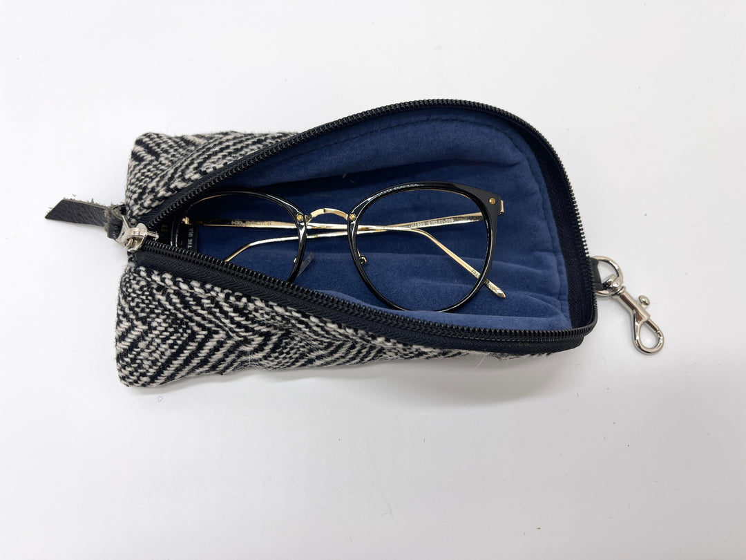 Eyeglasses in a herringbone-patterned case on a white background#color_crosswind-chevron
