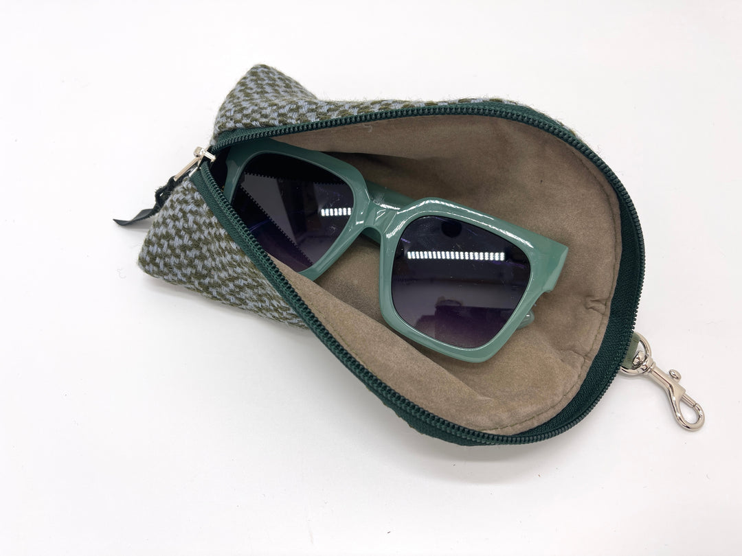 Green sunglasses in a patterned case on a white background#color_forest-tweed