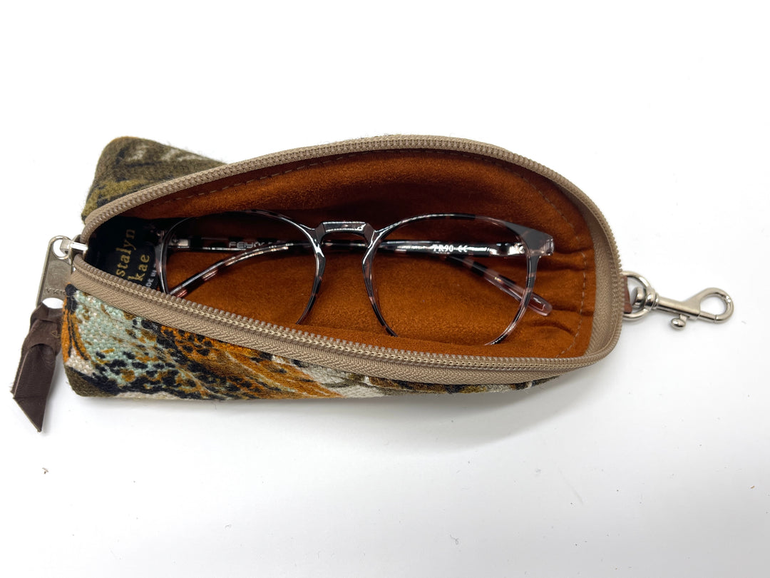 Orange floral eyeglass case with glasses inside on a white background#color_harvest-bloom