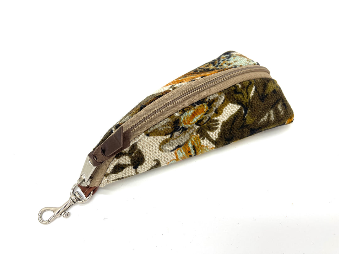 Floral-patterned pouch with a zipper and keychain clip on a white background#color_harvest-floral