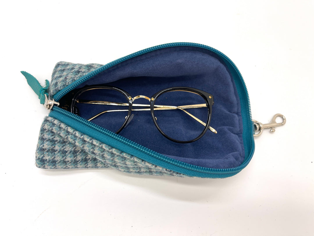 Blue fabric zippered case with glasses inside on a white background#color_highland-mist-check