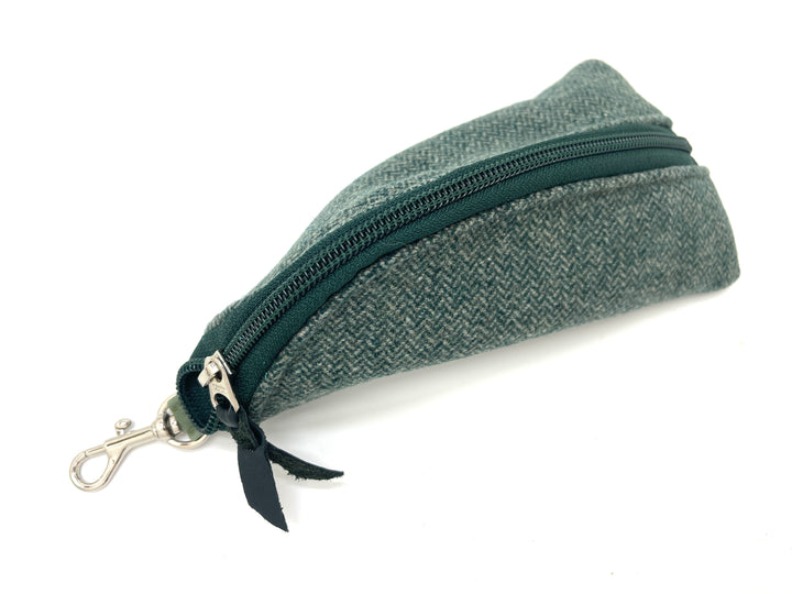 Green textured zippered pouch with a black ribbon on a white background#color_seafoam-houndstooth
