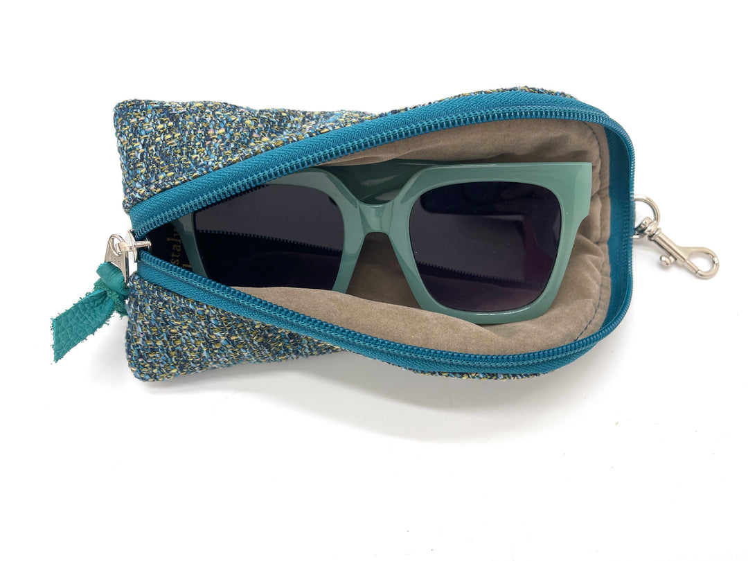 Blue textured zippered pouch with sunglasses inside on a white background#color_transatlantic-teal