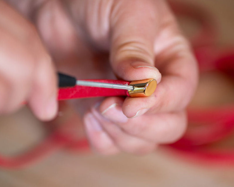 Close-up of hands offering bag repair service