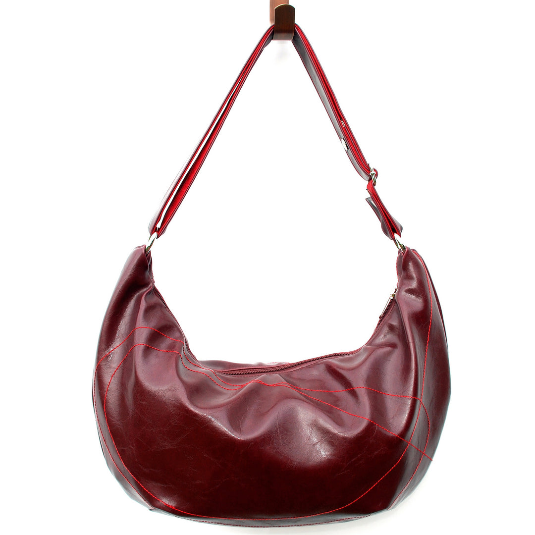 Red leather handbag with a strap on a white background#color_wine