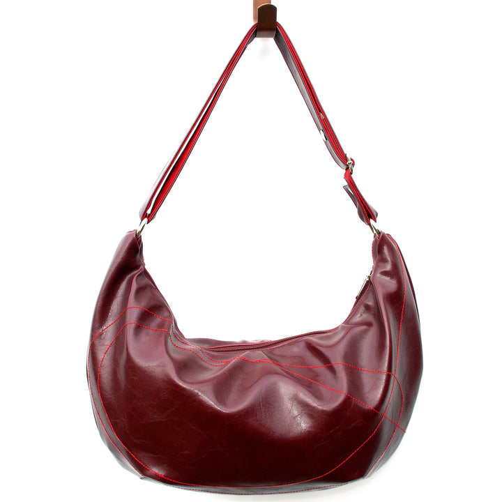Red leather handbag with a strap on a white background#color_wine