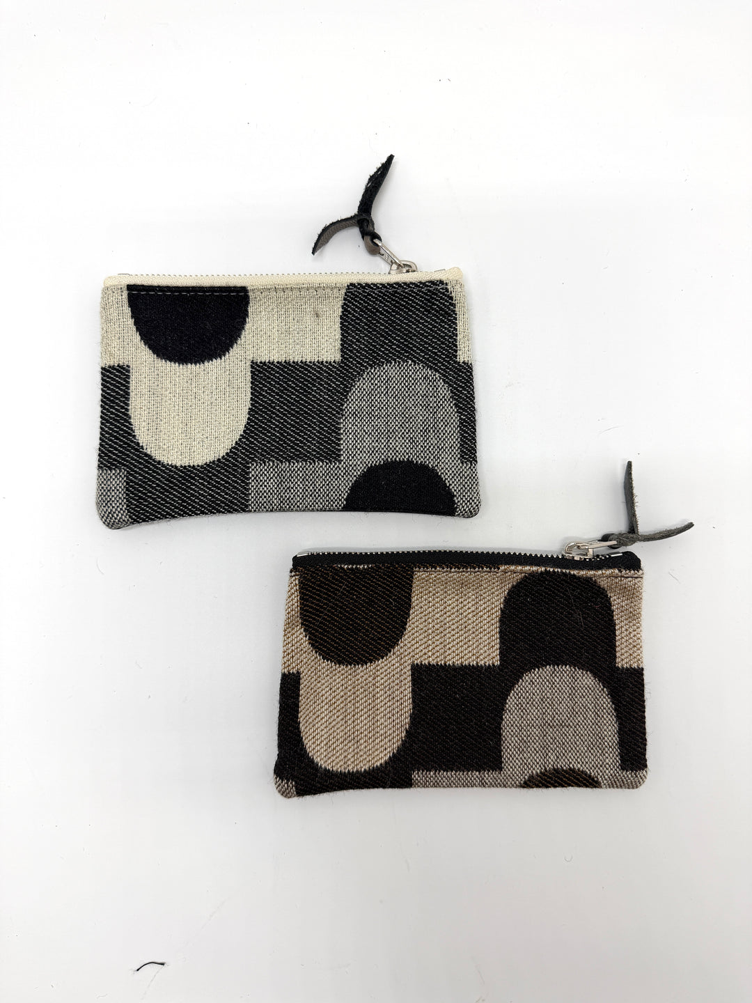 Two patterned coin purses on a white background#color_sky-arches-black-cream