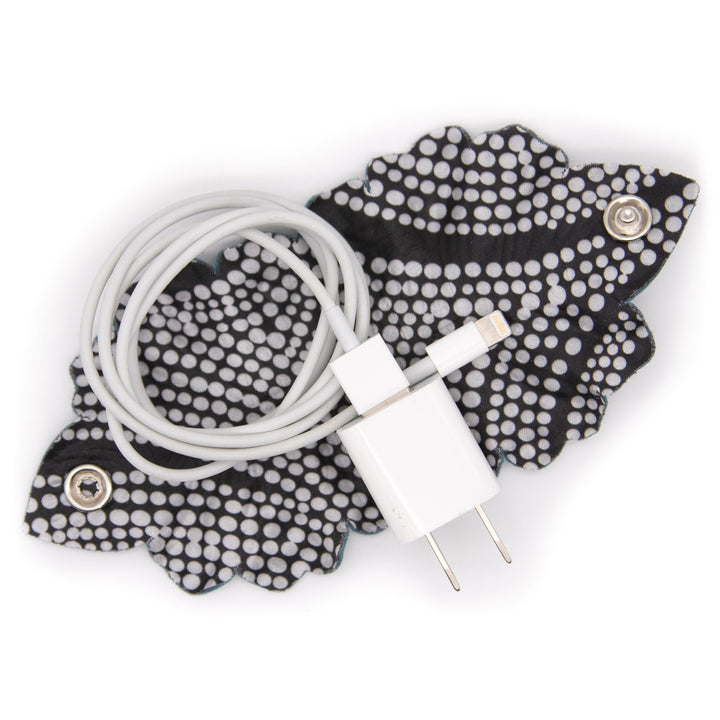 Laptop Leaf Cord Wrap with phone charger cord gathered inside